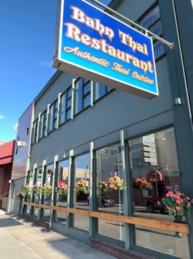 Bahn Thai Restaurant storefront with its blue sign and flower baskets in downtown Fairbanks
