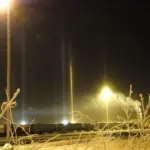 Light pillars rising through ice fog at the Fairbanks train station at night