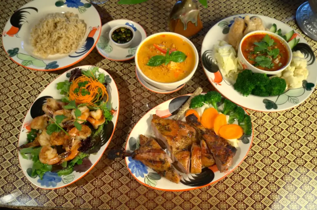 Table spread of several Thai curries and stir-fries served at Lemongrass Thai Cuisine