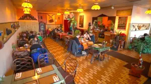 Warm-lit dining room at Lemongrass Thai Cuisine in Fairbanks with tiled floor, booths and hanging lamps
