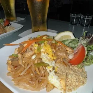 Pad thai from Mom's Kitchen in Fairbanks, topped with egg, crushed peanuts and lime