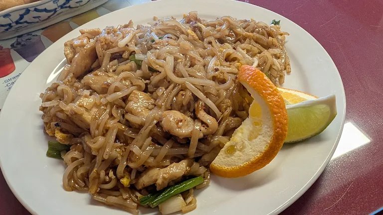 Plate of chicken pad thai with orange and lime at Nims Thai restaurant in Fairbanks