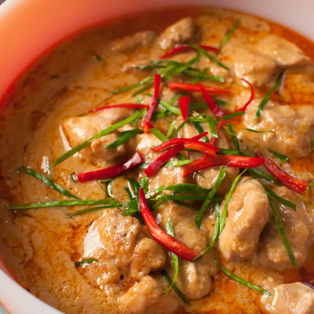 Chicken panang curry topped with thin strips of kaffir lime leaf and red chili