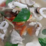 Clear tom yum soup with seafood, mushrooms and herbs