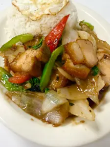 Crispy pork stir-fried with peppers and onion over rice with a fried egg at Yes! Noodle Soup