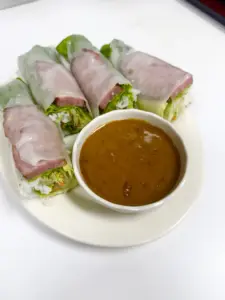 Fresh rice-paper rolls with a bowl of dipping sauce at Yes! Noodle Soup